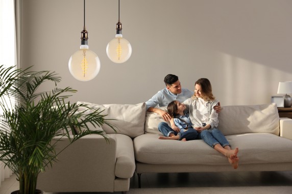 Family with little daughter resting on sofa in living room